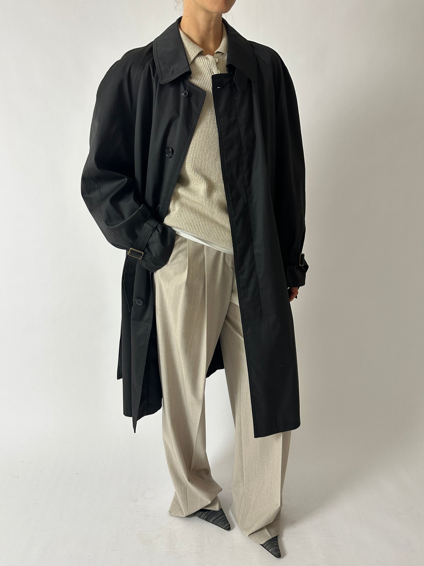 Vintage long trench coat with dropped shoulders in an off black color. The coat features a oversized fit for timeless style curated by NYN