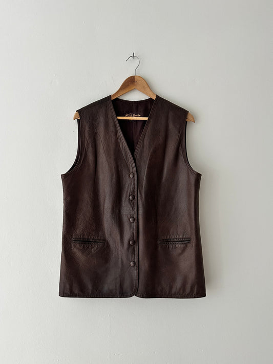 Brown leather vest on a wooden hanger against a white background