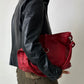 Vintage leather fitted jacket with funnel neck worn with a leather shoulder bag in bright red with silver ring detail. Timeless vintage outfit 
