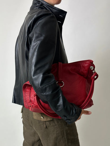Vintage leather fitted jacket with funnel neck worn with a leather shoulder bag in bright red with silver ring detail. Timeless vintage outfit 