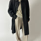 Vintage long trench coat with dropped shoulders in an off black color. The coat features a oversized fit for timeless style curated by NYN