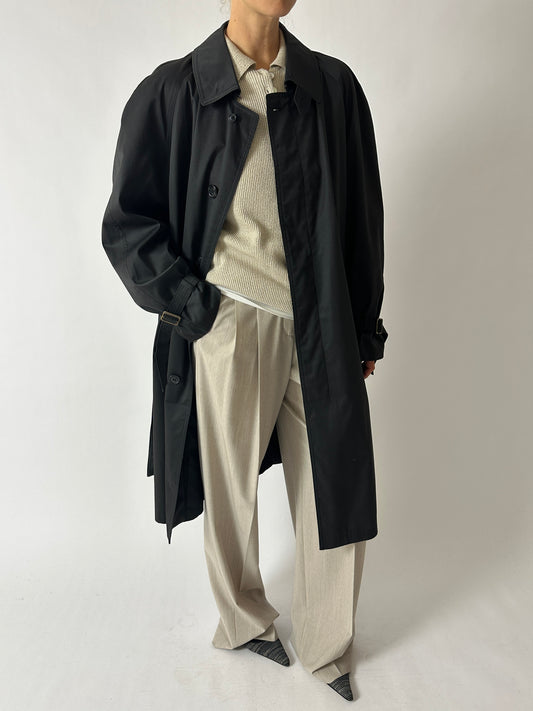 Vintage long trench coat with dropped shoulders in an off black color. The coat features a oversized fit for timeless style curated by NYN