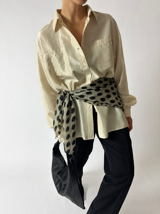 vintage oversized silk shirt in soft butter worn with a silk dotted scarf around the waist. Both curated by NYN