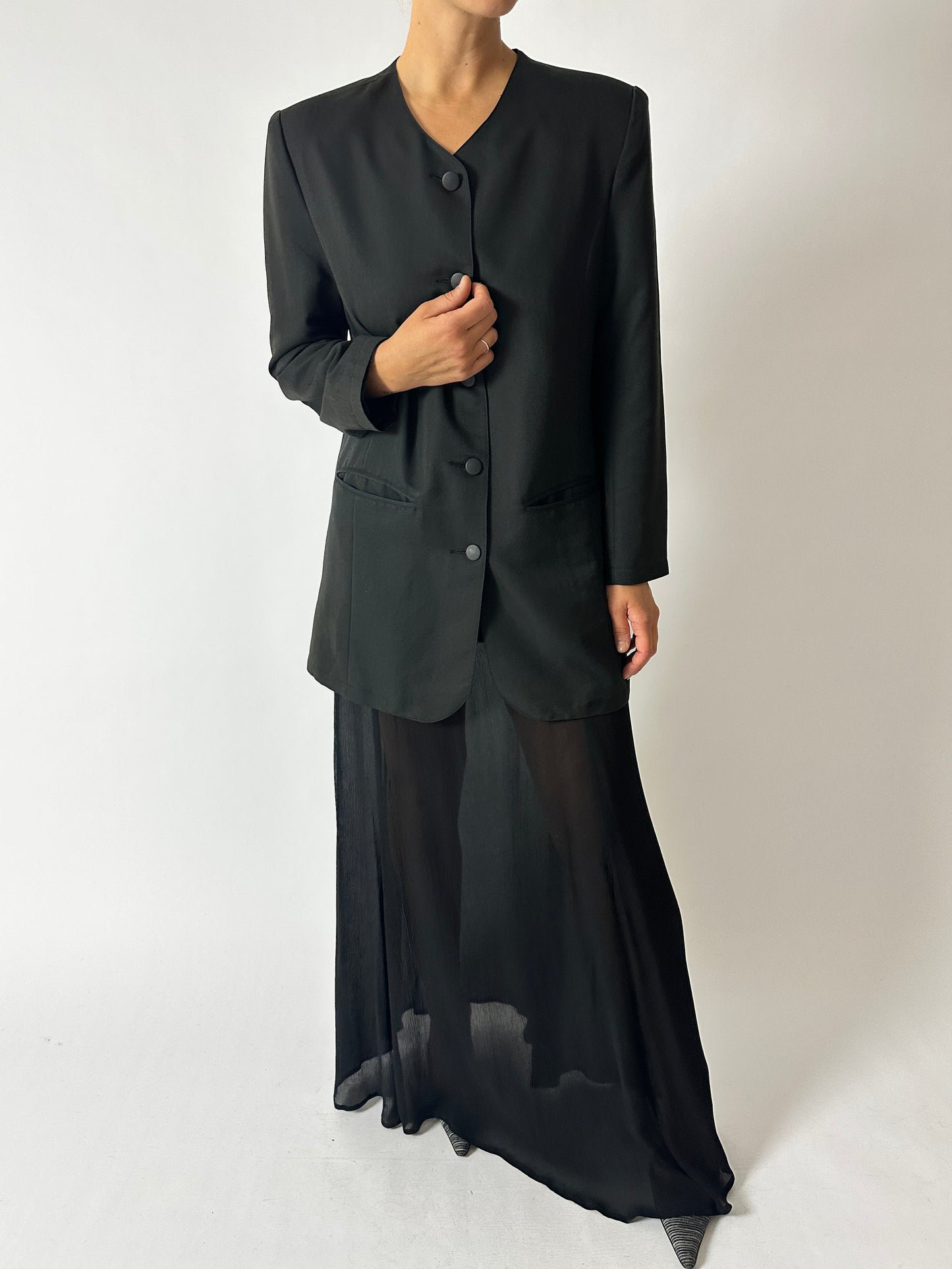 Vintage pleated maxi skirt in black worn with a collarless vintage blazer in off black. A timeless classic look with edge. Curated by NYN