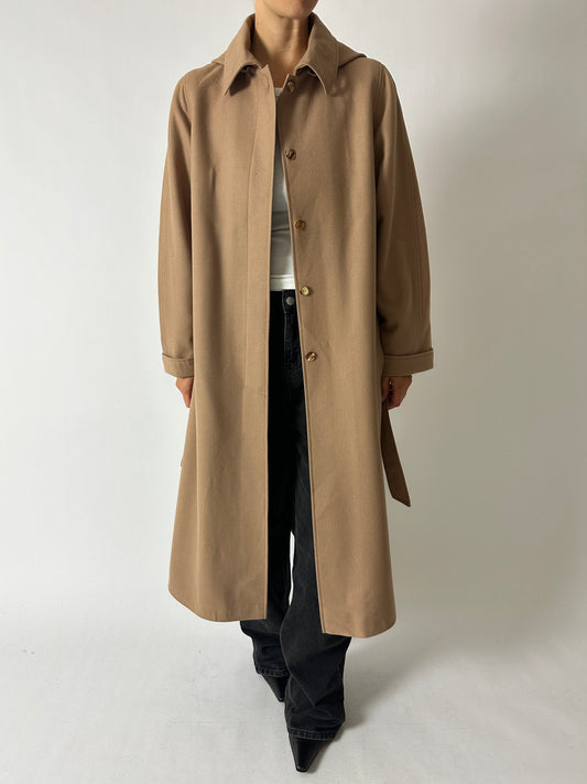 Long wool belted vintage coat in soft camel brown worn with wide leg dark grey denim and pointy vintage leather boots curated by NYN 